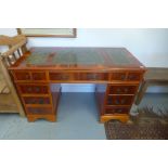 A modern yew veneer nine drawer desk, approx 122cm W x 75cm H x 61cm D