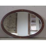 An Edwardian inlaid mahogany oval mirror - 100cm x 67cm