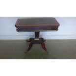 A Regency Rosewood and satinwood ormulu mounted foldover card table on a quatrefoil base, with brass