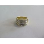 An 18ct yellow gold diamond three band ring, with 21 diamonds, each approx 0.30ct, total weight