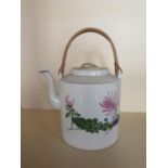 An oversized oriental teapot with floral decoration, 20cm tall, small chip to lid and cracks to body