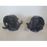 A pair of bronze rams heads, 15cm tall, 20cm wide, with good patina colour