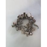 A silver charm bracelet, approx 4.6 troy oz