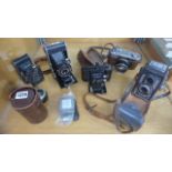 A collection of five assorted cameras and accessories including a Yashica 44