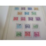 A collection of World stamps on pages, stock-cards and albums to include old auction Lots â€“