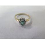 A 9ct gold emerald and diamond ring, size M, approx 1.4 grams, with some abrasions to central stone,