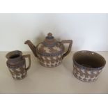 A 19th century Doulton, Lambeth silicon ware teapot and lid, together with sugar bowl and milk jug