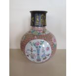 A Chinese 18th century Qianlong period porcelain vase decorated with precious objects in panels on a