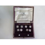 A gentlemans waistcoat button, cufflink and stud set, marked 9ct and 18ct, retailed by Mappin and