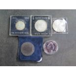Five assorted coins to include a Thaler, 1885 silver dollar 1964, half dollar 1964, half dollar ,