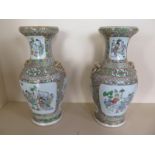 A pair of Famille Verte vases with lions mask ring handles, 39cm tall, small chip to rim of one