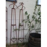 A pair of hand forged wrought iron triangular section garden obelisks with scroll finials - 231cm
