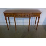 A walnut breakfront three drawer side table on square tapering legs, 76cm tall x 122cm wide, x