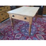 A 19th century pine kitchen table on turned legs, and a drawer, 122cm x 83cm
