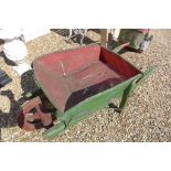 A vintage wooden painted wheel barrow, ideal for planting out