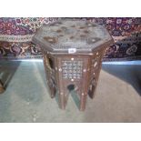 An octagonal carved and inlaid Islamic Damascus type side table in need of restoration, 54cm tall