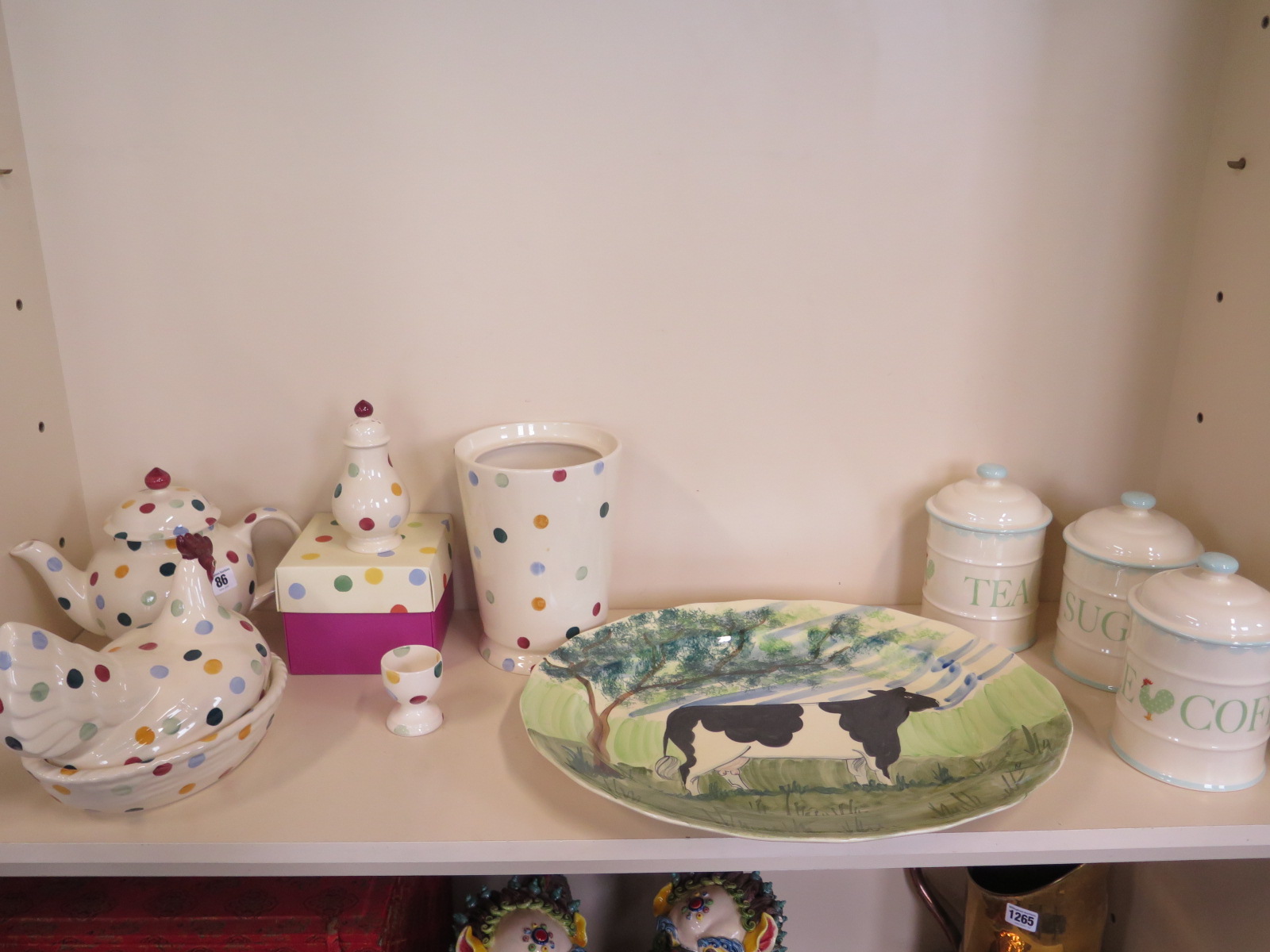 Five Emma Bridgewater items including a sugar shaker, biscuit barrel missing its lid, and three
