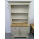 A Neptune Chichester style dresser with an open shelved top over two drawers and two cupboard doors,