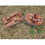 A quantity of vintage terracotta plant pots, each 9cm high, in two vintage plastic coated metal