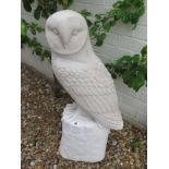 A large reconstituted stone garden sculpture of a barn owl resting on a log perch - 76cm H