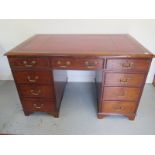 A good quality 19th century desk with a tooled leather top over nine drawers with brass swan neck