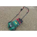 A Qualcast electric lawn raker, GLR750 - in good working order