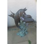 A bronze dolphin water feature, 108cm tall