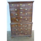 A George I walnut and cross banded chest on chest, with oak lined drawers and sides with brass