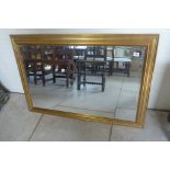 A gilt wall mirror originally bought from John Lewis, 69cm x 98cm