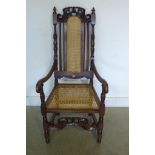 A 20th century solid oak and cane throne style occasional chair, fully restored