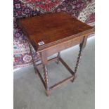 A 1930s oak side table on barley twist legs