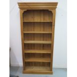 A modern pine bookcase with adjustable shelving, 210cm tall x 100cm wide x 27cm deep, shelf depth