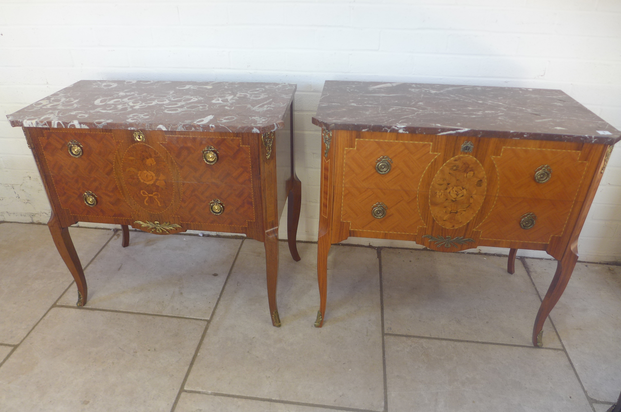 A near pair of walnut and inlaid antique style marble topped chests with two drawers - in very