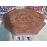 An Octagonal folding Eastern side table, 51cm tall x 77cm wide