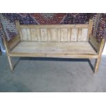 An early 19th century pine day bed/settle, 182cm W x 74cm D