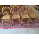 A set of four elm and beech stick back dining chairs