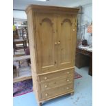 A modern pine wardrobe on chest with two doors above three drawers, in two pars, 194cm tall x 94cm x