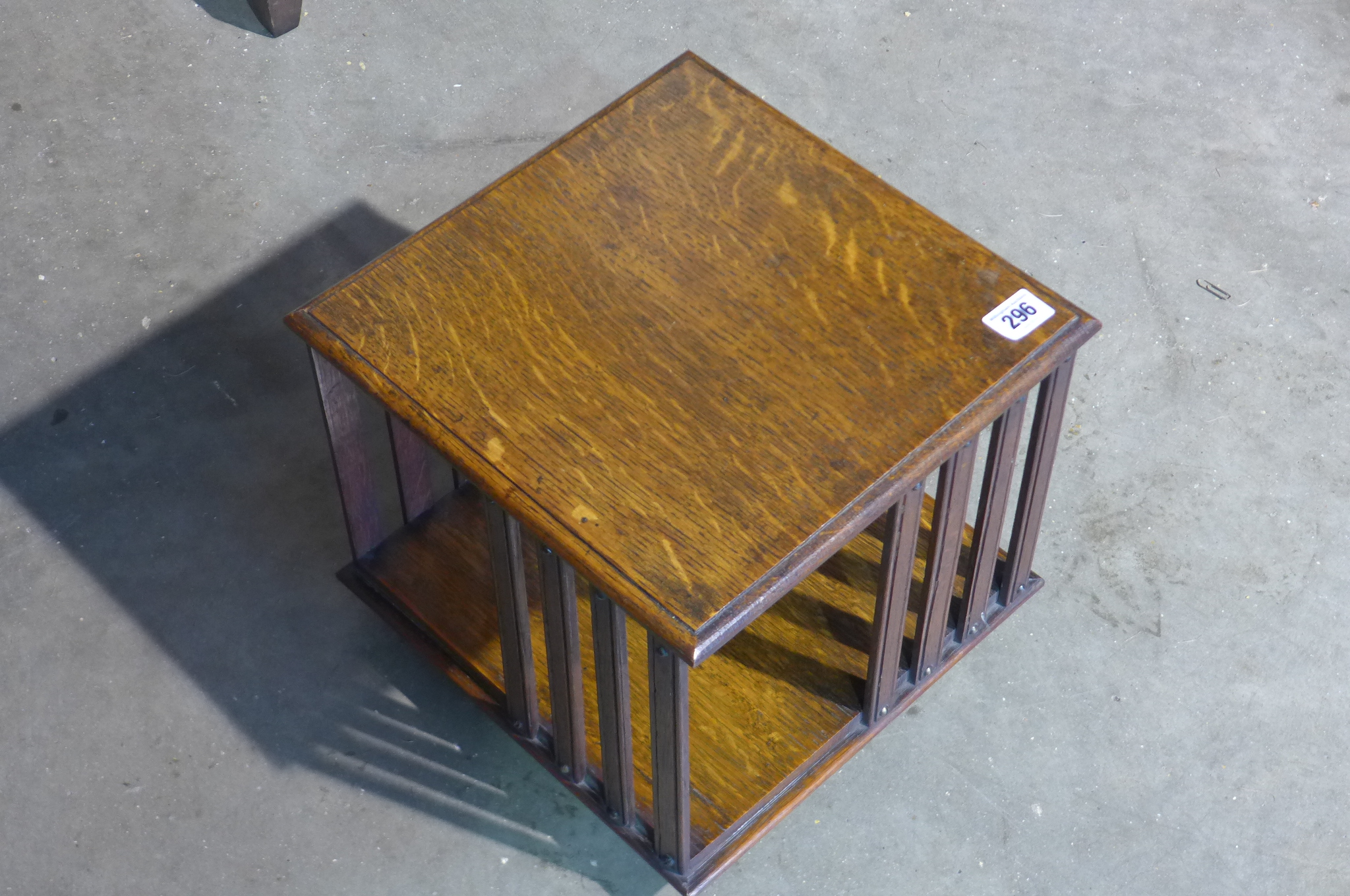 A small table top revolving oak book case, 28cm tall x 29cm x 29cm