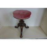 A Victorian walnut revolving piano stool