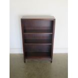 A 20th century mahogany open bookcase with adjustable shelves, bares a label for Bradley