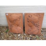 A pair of Renaissance style terracotta garden wall plaques depicting two helmeted gods - 46cm H x