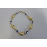 A 14ct bracelet made up of alternating elephant and blue stone set links, approx 18.5cm long, approx