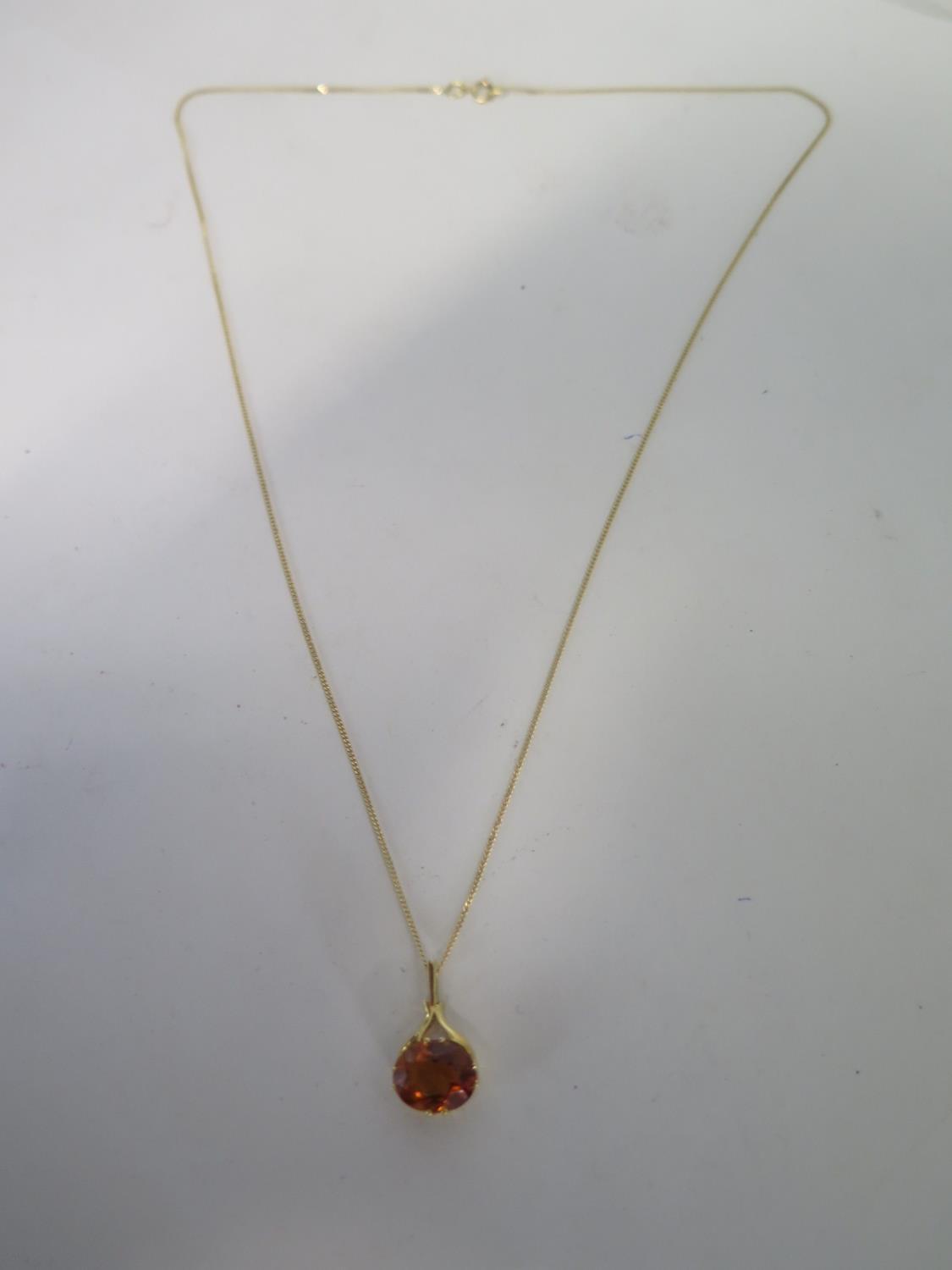 An 18ct yellow gold topaz pendant on an 18ct yellow gold 45cm chain, stone approx 9x7mm, in good