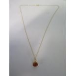 An 18ct yellow gold topaz pendant on an 18ct yellow gold 45cm chain, stone approx 9x7mm, in good