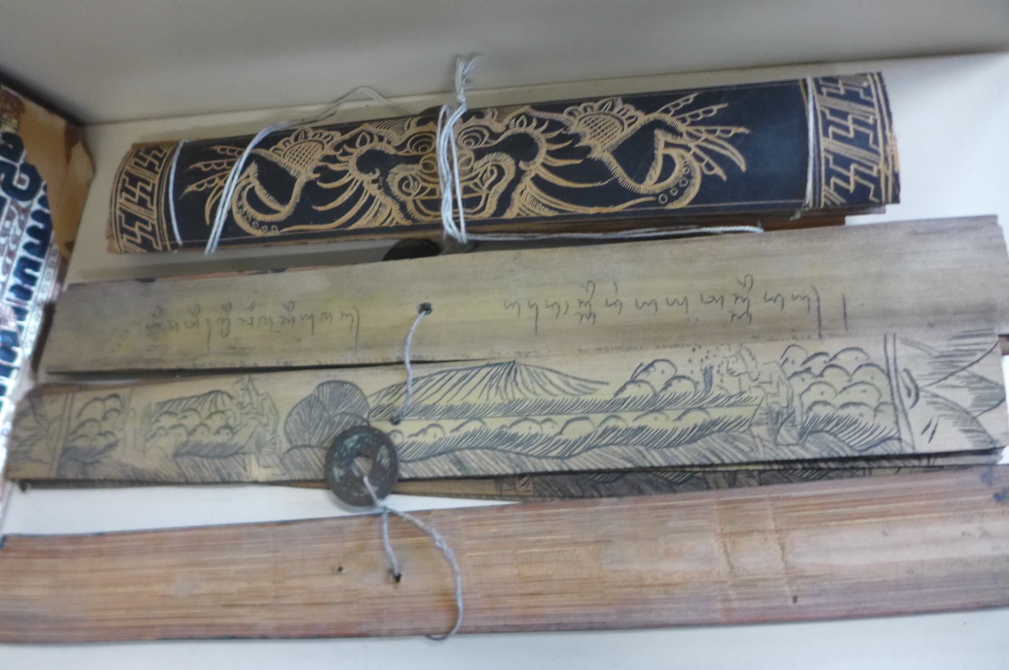 A collection of Tibetan prayer scripts, including a carved block - 15cm long - Image 4 of 6
