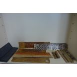 A collection of Tibetan prayer scripts, including a carved block - 15cm long