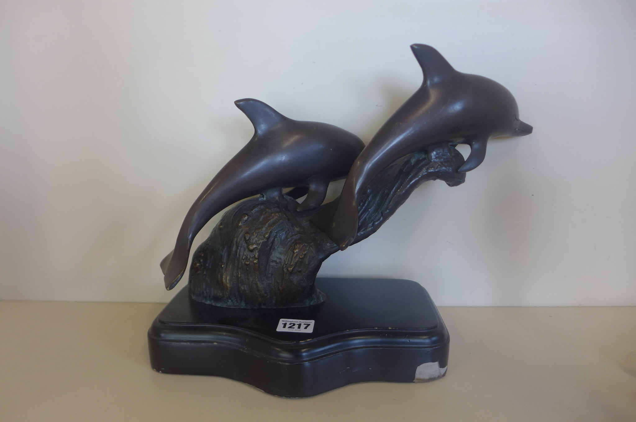 A bronzed group of dolphins, 29cm tall - some damage to base otherwise good and two bronze figures