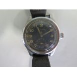 A Cyma Military Dirty Dozen manual wind wristwatch with black dial and crows foot, reverse side