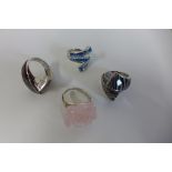 Three silver designer David Sigal rings and a silver ring set with large pink quarts, approx 1.1