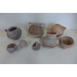 A collection of eight earthenware pots, possibly ancient, largest 14x14 cm